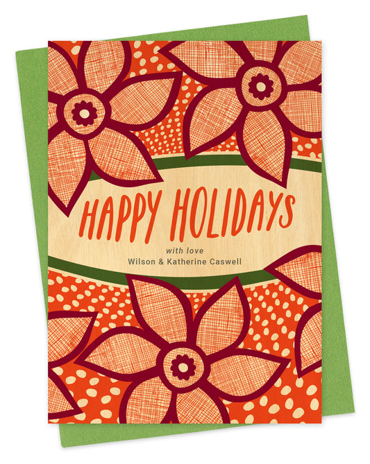 Customizable paper holiday card with red poinsettias, “Happy Holidays” text and a personal message on a printed birch wood background. Shown with a green envelope.