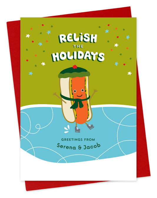 Customizable paper holiday card featuring a cheerful ice skating hot dog, a "Relish the Holidays" sentiment and a personal greeting. Shown with a red envelope.