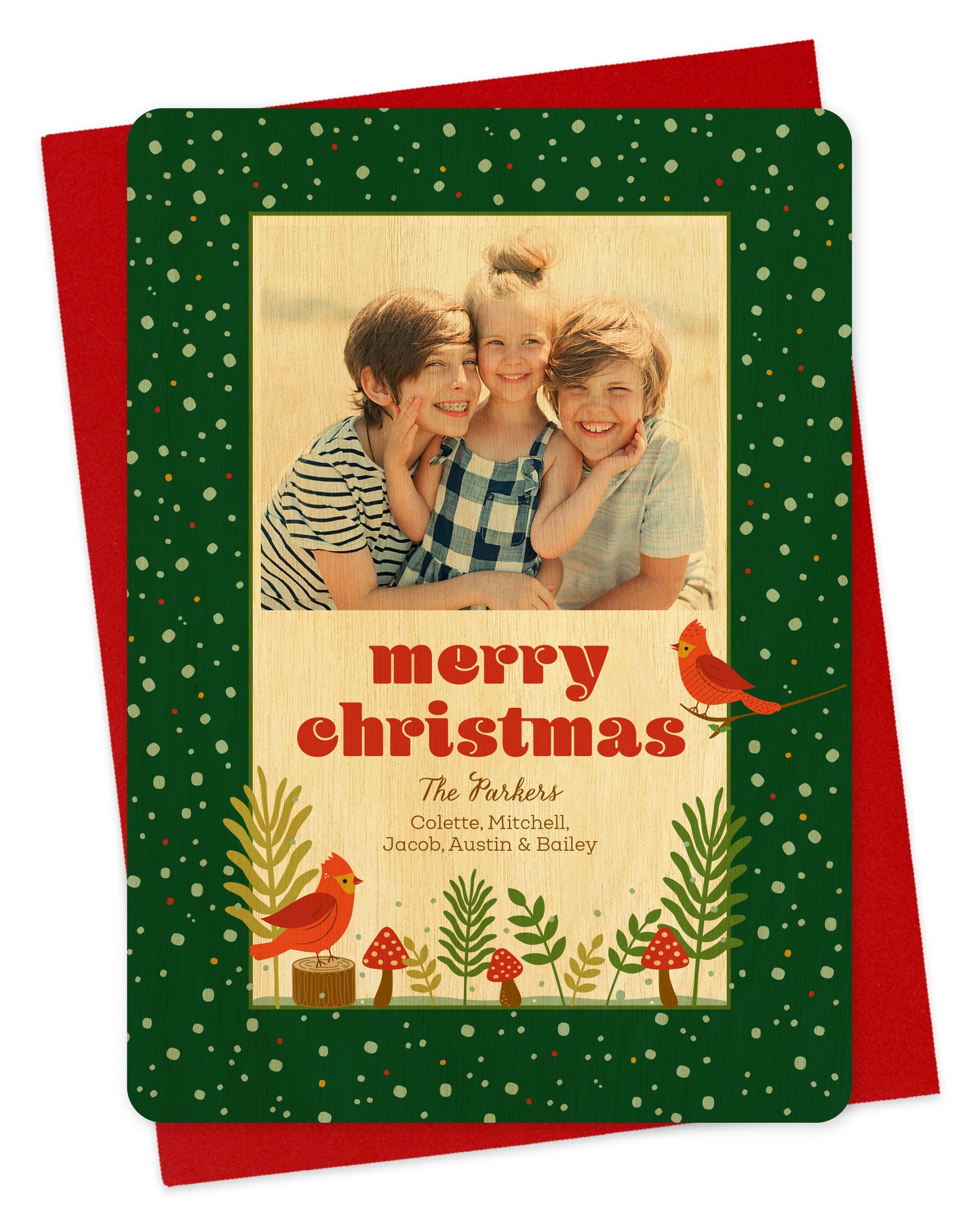 Personalized holiday card with cardinals and mushrooms on green background, printed on birch wood.