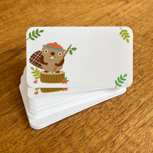 A stack of small white Beaver note cards with rounded corners, featuring a cute beaver wearing an orange beanie standing on a tree stump and green leaf details in the corners.