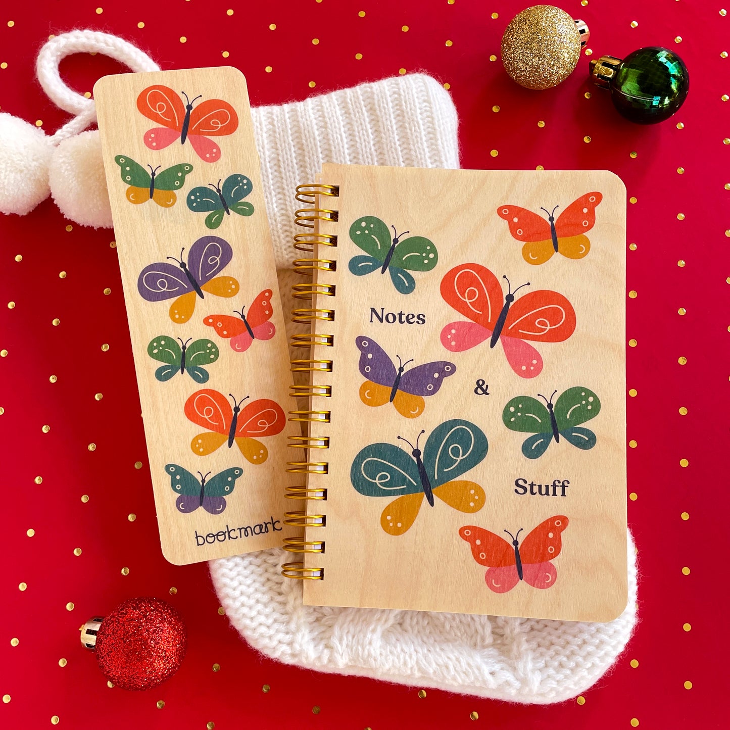 Wood bookmark and notebook with butterfly designs on a red background