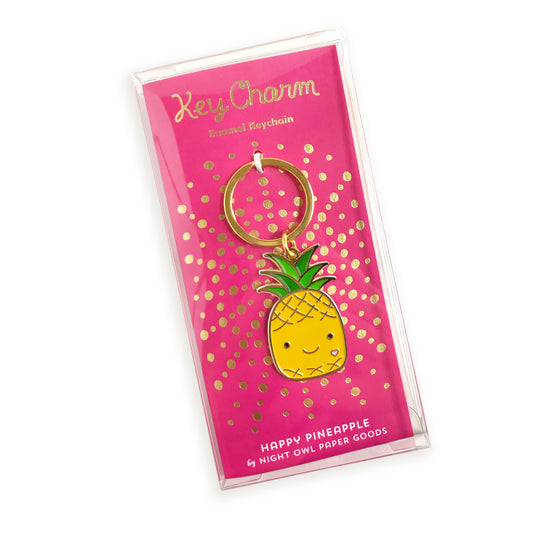 Happy Pineapple enamel keychain on gold foil stamped backer card packaged in a clear gift box. Backer card reads "Key Charm Enamel Keychain" at top and "Happy Pineapple by Night Owl Paper Goods" at bottom.