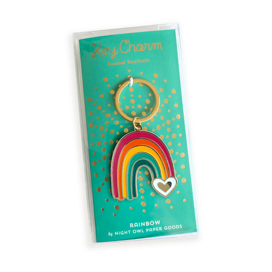 Rainbow enamel keychain on gold foil stamped backer card packaged in a clear gift box. Backer card reads "Key Charm Enamel Keychain" at top and "Rainbow by Night Owl Paper Goods" at bottom.