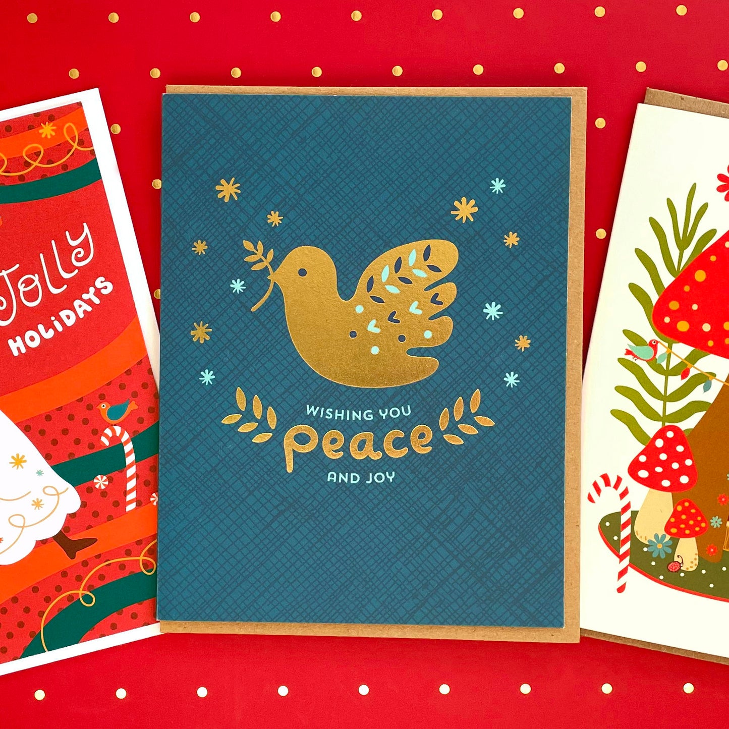 Blue holiday greeting card with a gold foil dove and text 'Wishing you peace and joy'