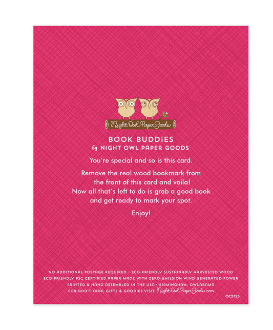 Back of bookmark card. Pink background with a crosshatch pattern and text that reads "Book Buddies by Night Owl Paper Goods. You're special and so is this card. Remove the real wood bookmark from the front of this card and voila! Now all that's left to do is grab a good book and get ready to mark your spot. Enjoy! No additional postage required. Eco-friendly sustainably harvested wood. Eco-friendly, FSC certified paper made with zero-emission wind generated power. Printed & hand assembled in the USA..."