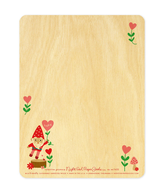 Back of Valentine Gnome wood card, which is predominantly blank for a handwritten personal greeting. Along the bottom is a small gnome and mushrooms design, the company logo and text that reads "eco-friendly sustainably harvested wood - made in the usa - birmingham, owlabama - nightowlpapergoods.com"