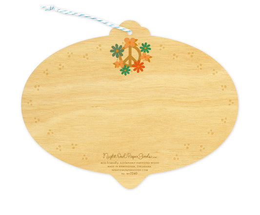 Back of Peace Bulb wood ornament holiday card, which is die-cut in the shape of a bulb and features a floral peace sign at the top, faint dot designs along the edges and space to write a personal greeting. Along the bottom is the company logo and text that reads "eco-friendly sustainably harvested wood - made in birmingham, owlabama - nightowlpapergoods.com