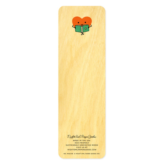 Back side of wooden bookmark with a heart-shaped character holding a book