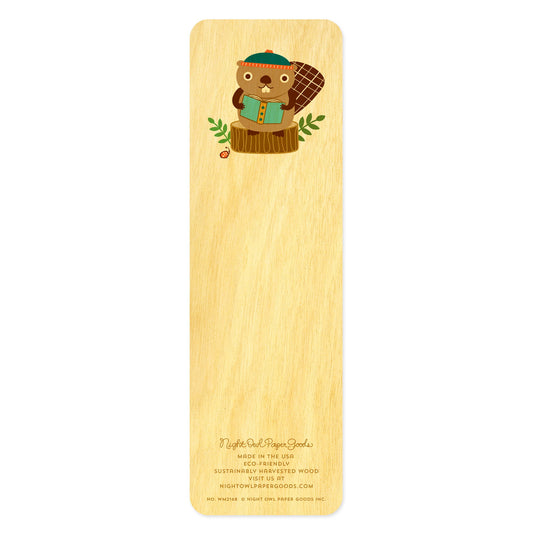 Back side of wooden bookmark with cartoon beaver wearing stocking cap sitting on a tree stump reading a book