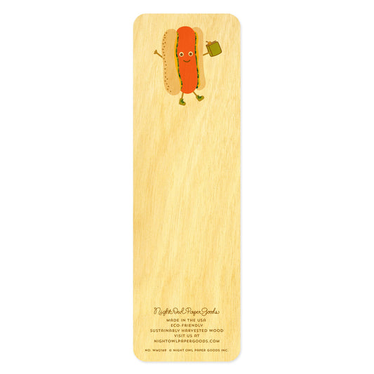 Back side of wooden bookmark with a cartoon hot dog wearing boots and carrying a book