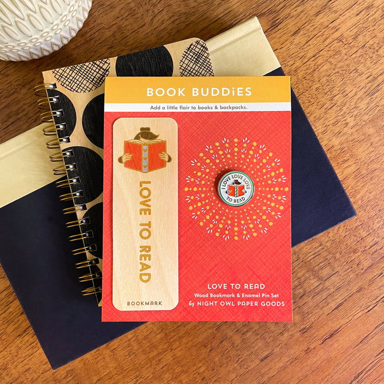 Wood bookmark with illustrated female head in a book and matching Love Love Love to read enamel pin. The gift set is with a real wood notebook with black polka dots.
