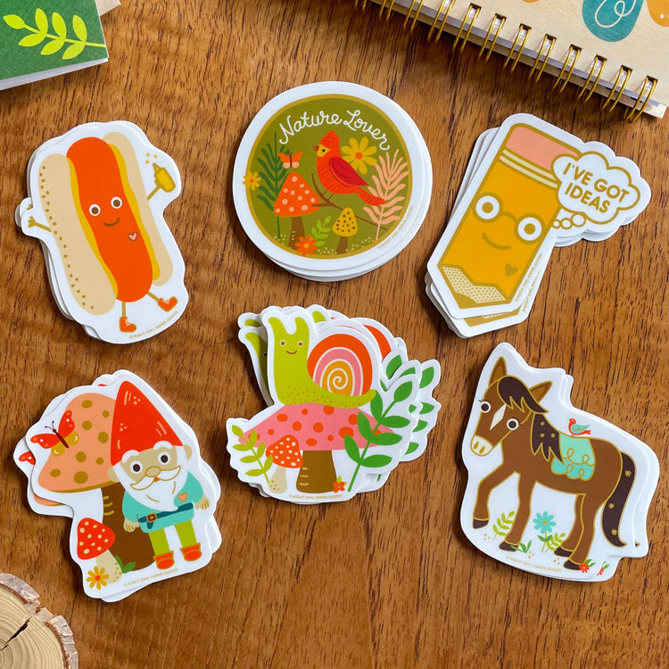 Group of cheerful, vibrant vinyl stickers, including a hot dog, cardinal, pencil, gnome, snail and horse