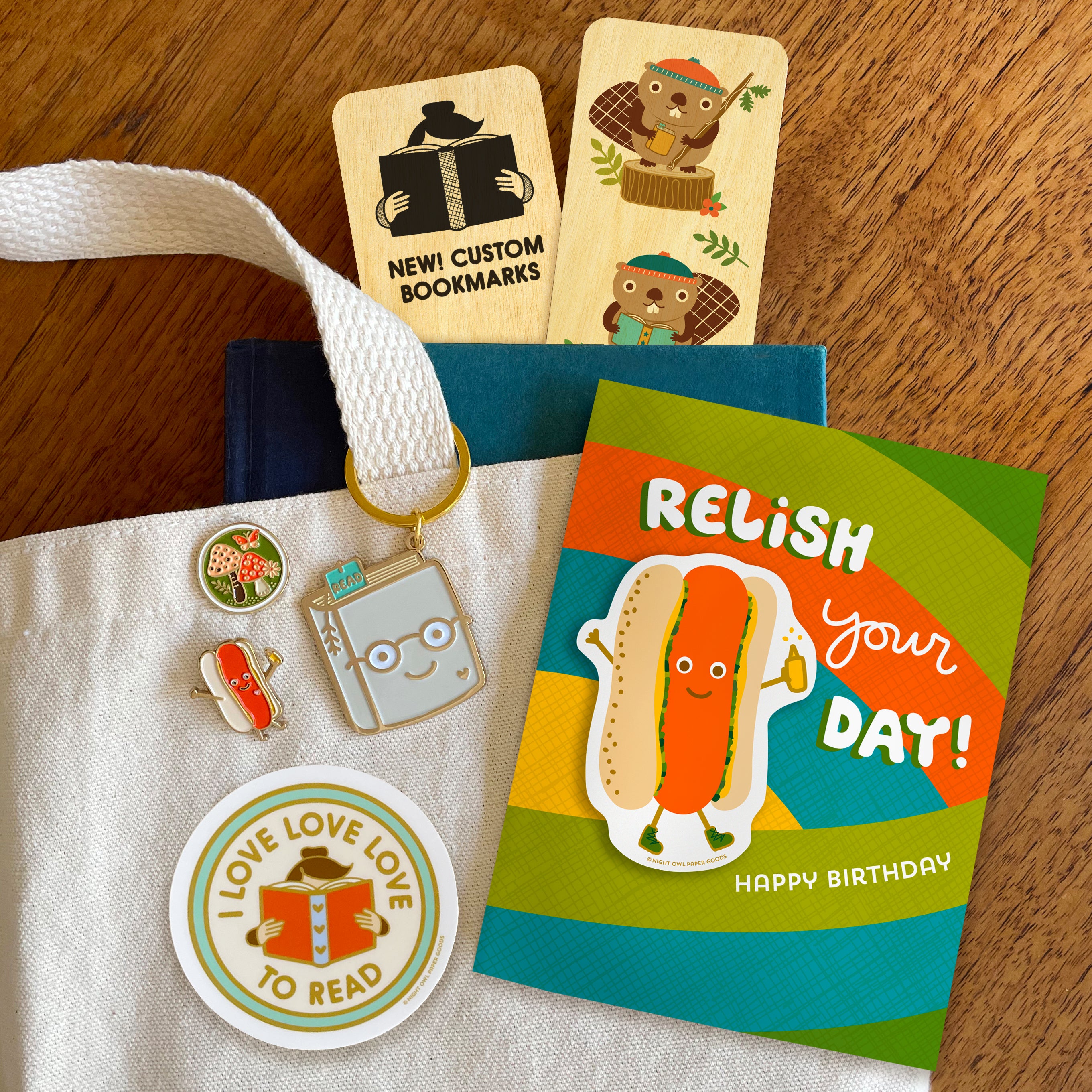 Wholesale Catalog Cover featuring bookmarks, enamel pins a keychain, a vinyl sticker and a birthday greeting card