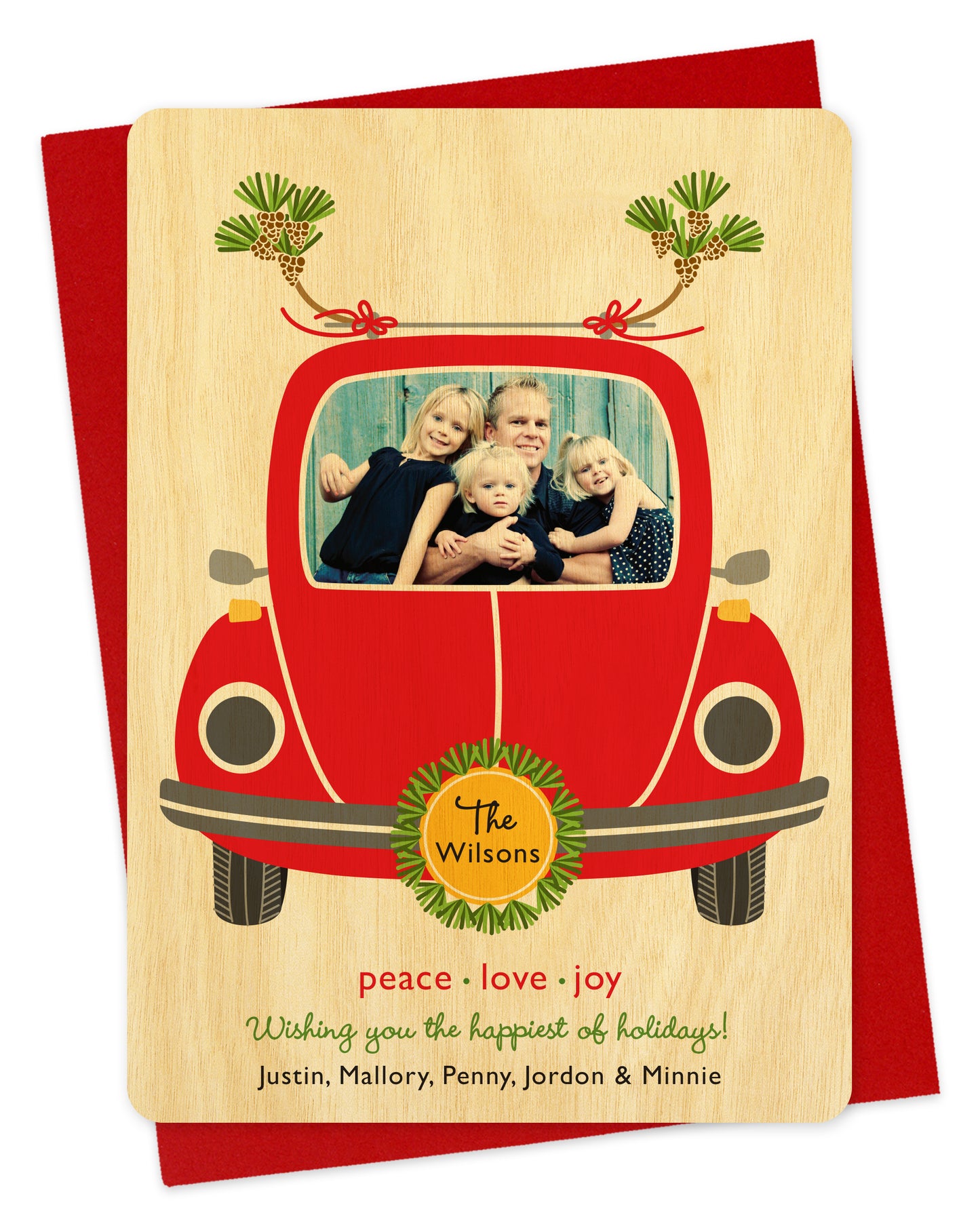 Customizable wood holiday card featuring your photo in the windshield of a red car. Features family name on the license plate and a personal greeting at the bottom of the card. Shown on a red envelope.