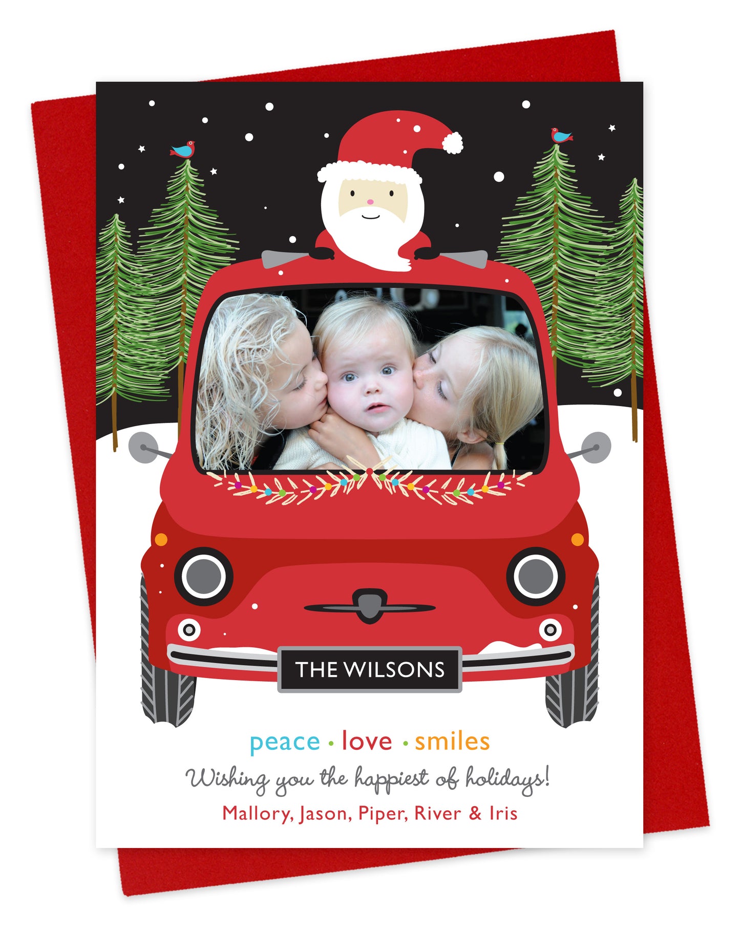 Customizable paper holiday card featuring your photo in the windshield of a red car with santa riding on top. Features family name on the license plate and a personal greeting at the bottom of the card. Shown on a red envelope.