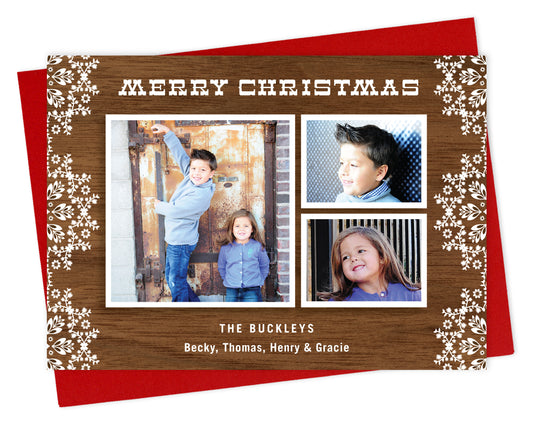 Customizable paper holiday card featuring 3 photos framed by printed walnut wood grain, festive doily designs, "Merry Christmas” text at the top and a personal greeting near the bottom. Shown with a red envelope.
