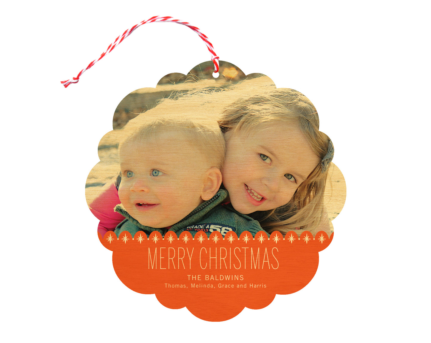 Front of customizable birch wood holiday ornament card featuring a photo with a red sparkle border, “Merry Christmas” text and a personal message. Round ornament with scalloped edges.