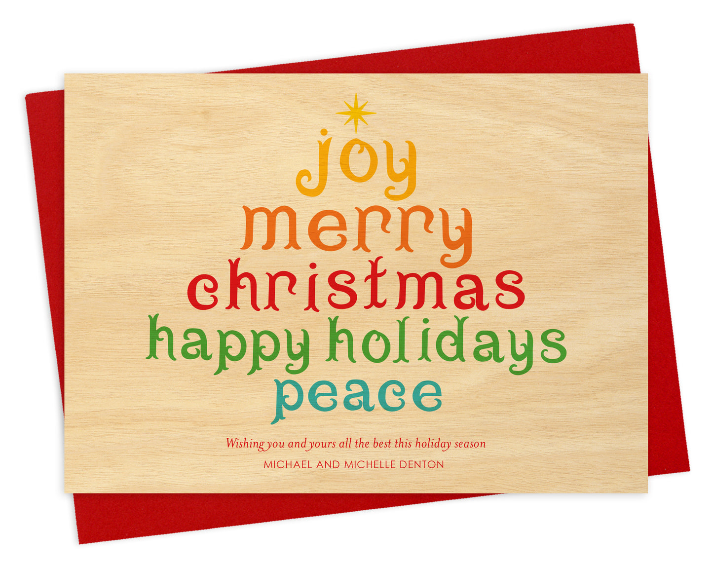 Front of personalized wood holiday card  featuring a colorful tree formed from festive “Joy, Merry Christmas, Happy Holidays, Peace” text on a printed birch wood grain background. Shown with red envelope.