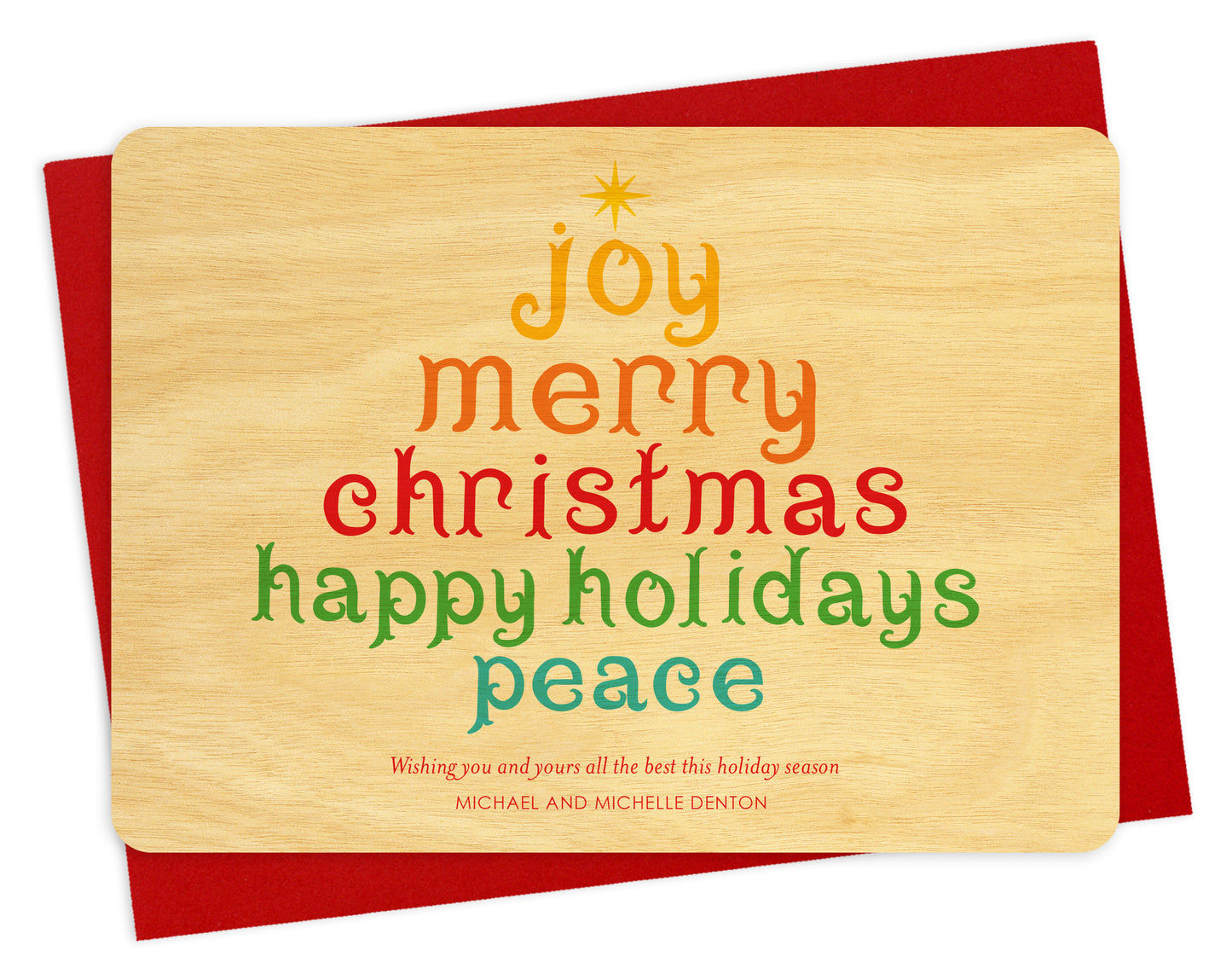 Front of personalized wood holiday card  featuring a colorful tree formed from festive “Joy, Merry Christmas, Happy Holidays, Peace” text on a birch wood grain background. Shown with red envelope.