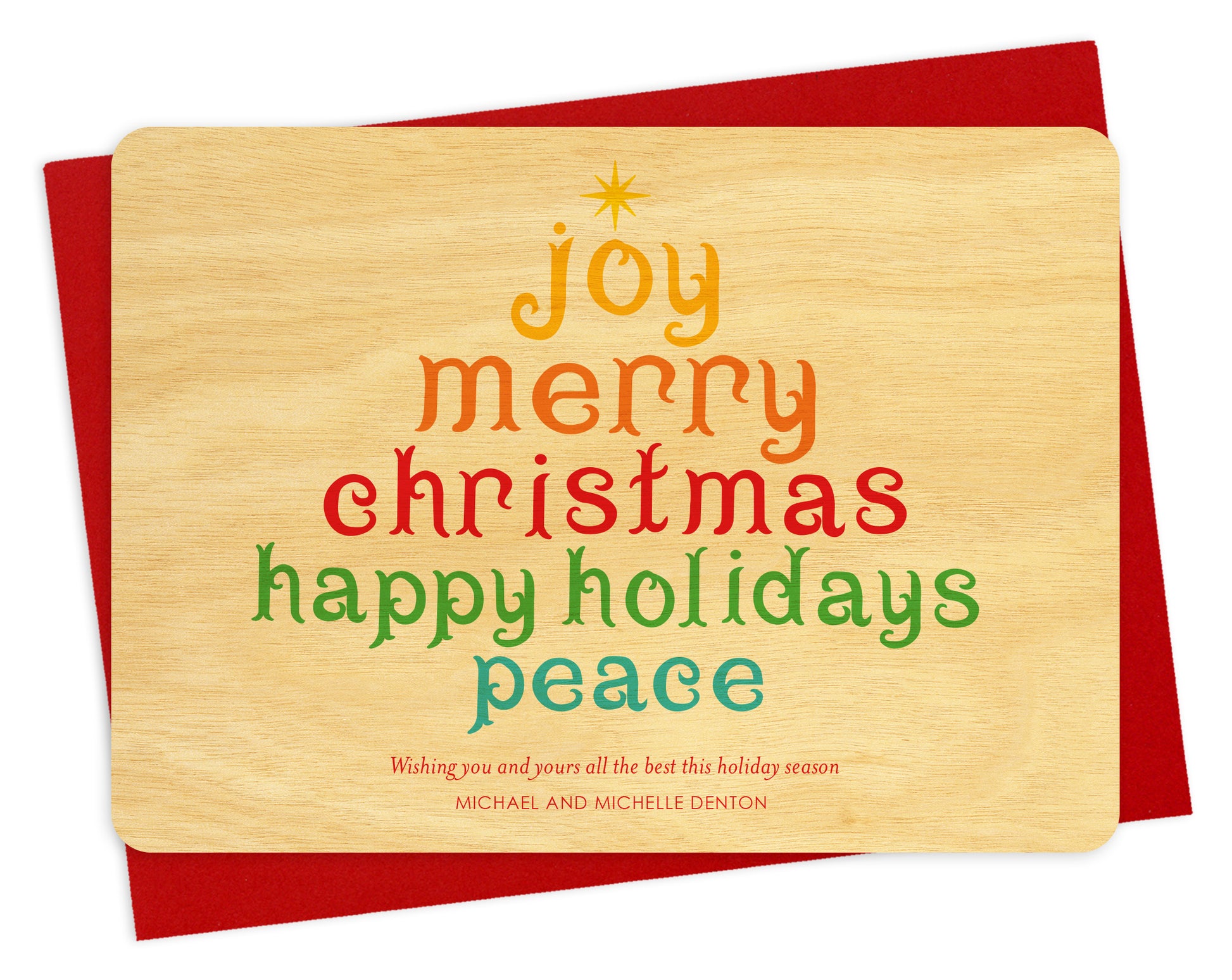 Front of personalized wood holiday card  featuring a colorful tree formed from festive “Joy, Merry Christmas, Happy Holidays, Peace” text on a birch wood grain background. Shown with red envelope.