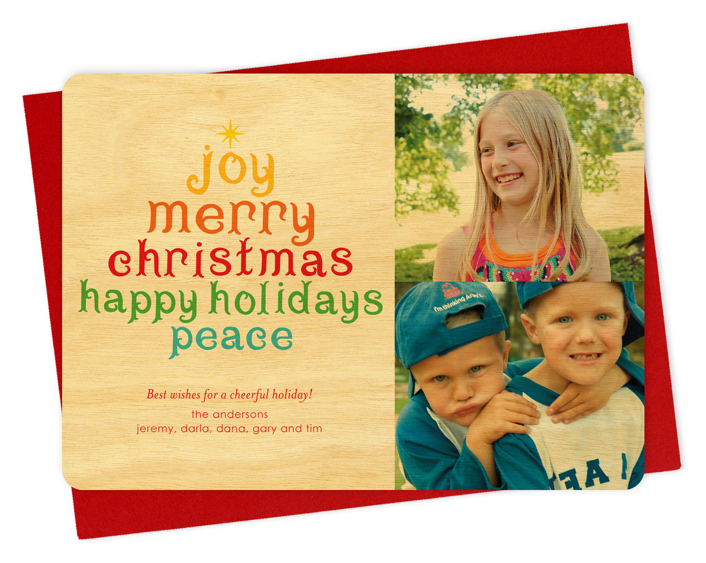 Customizable wood holiday card featuring your photo on the right and a colorful tree formed from the words “Joy, Merry Christmas, Happy Holidays, Peace,” with a personal greeting on the left. Shown with a red envelope.