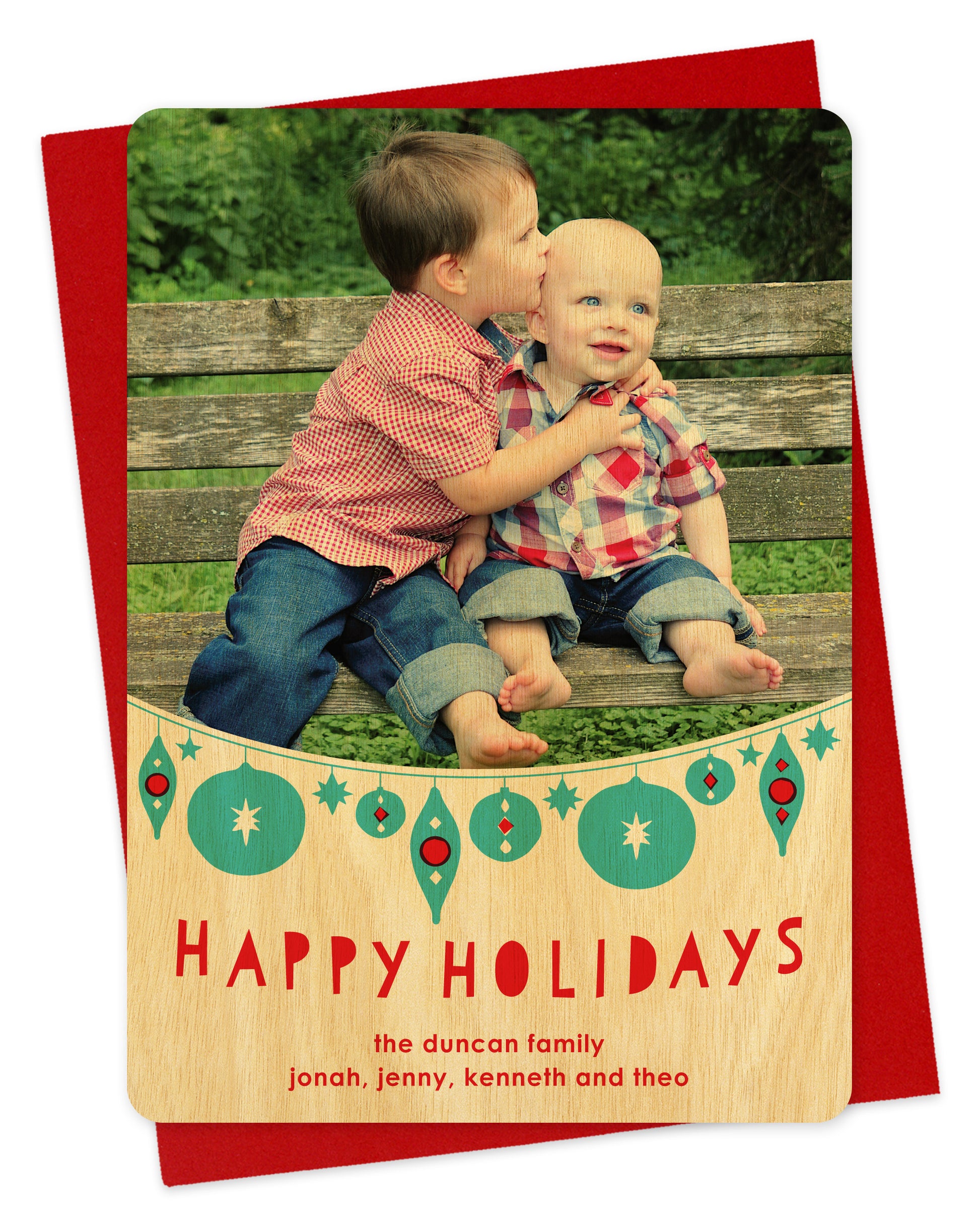 Customizable wood holiday card featuring your photo, festive aqua and red hanging ornaments and 'Happy Holidays' text and a personal greeting. Shown on a red envelope.