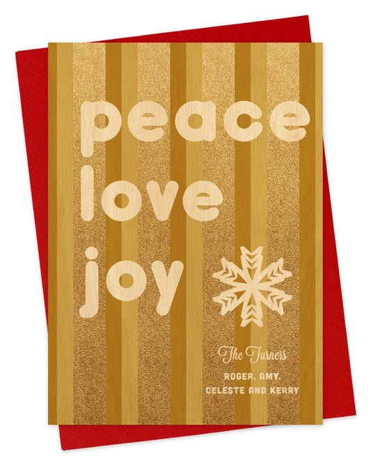 Customizable paper holiday card featuring glittering gold vertical stripes, a snowflake, a “Peace Love Joy” message and a personal greeting. Shown with a red envelope.