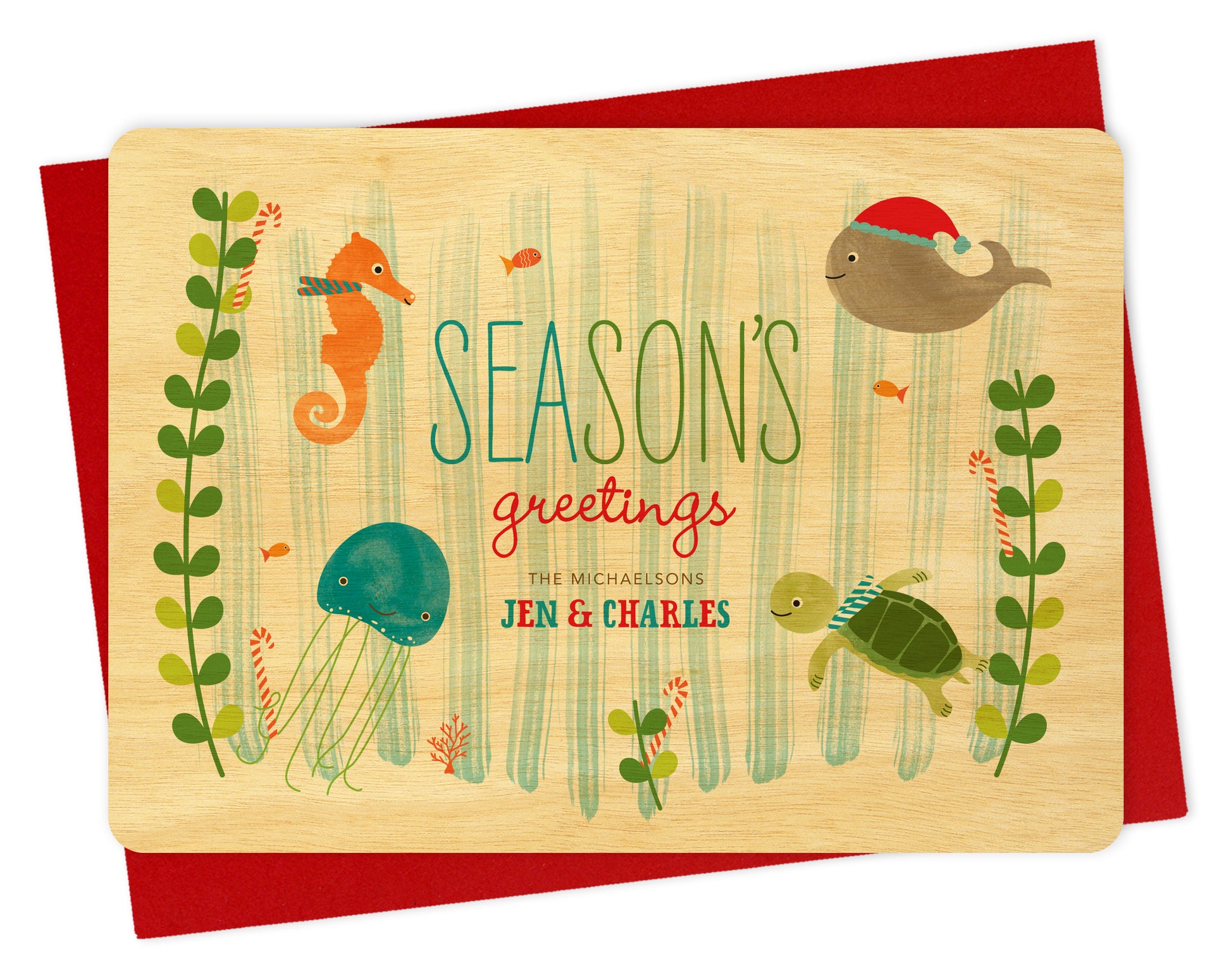 Front of personalized wood holiday card with cute marine sea creatures, "Season's Greetings" text and a personalized message on a birch wood background. Shown with a red envelope. 