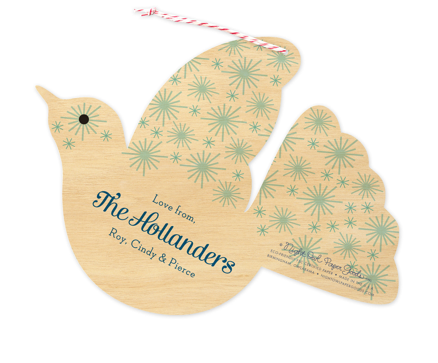 Back of personalized dove-shaped paper holiday ornament card with a personal greeting and a star pattern on a printed birch wood grain background.