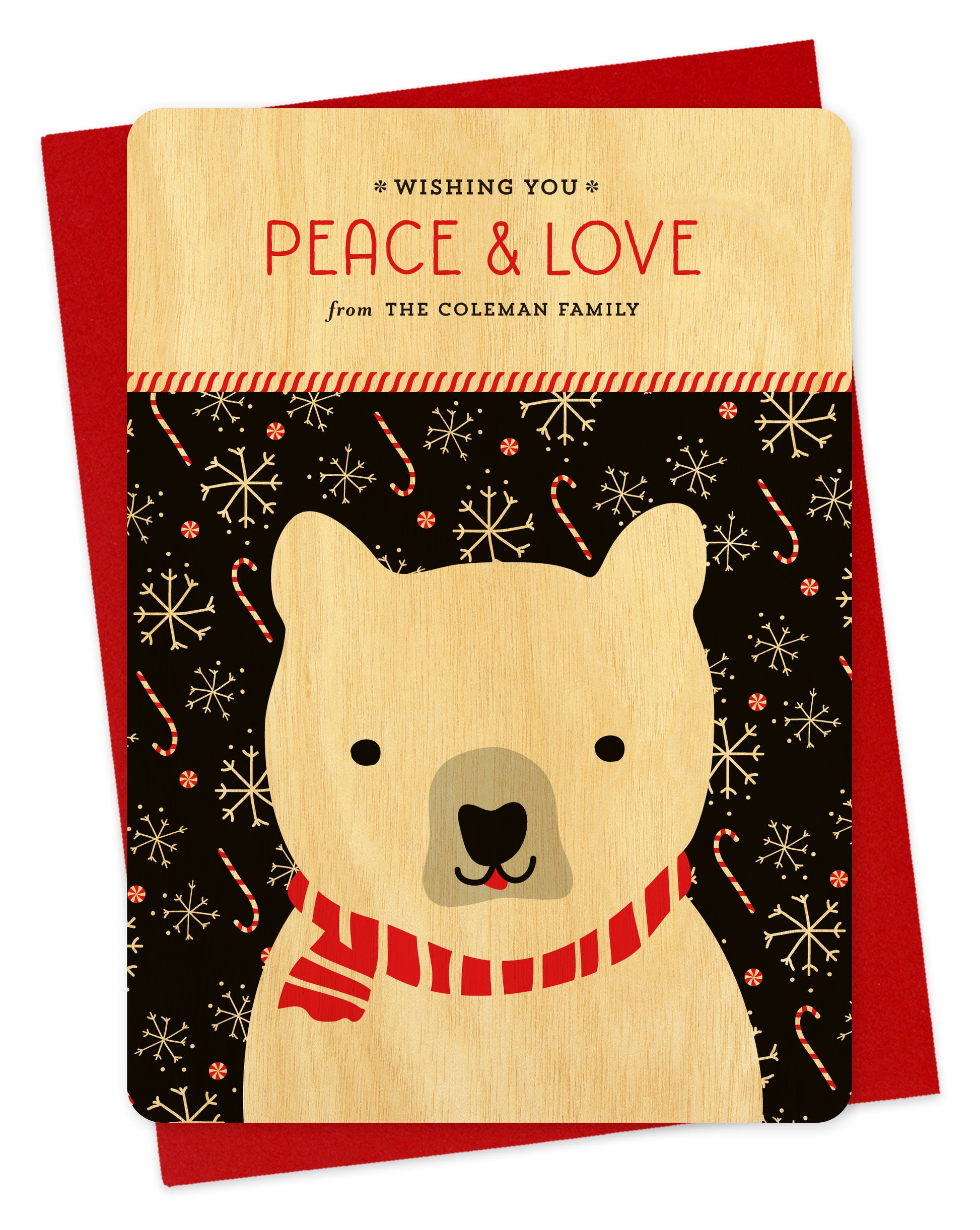 Customizable birch wood holiday card featuring a polar bear on a festive black background, “Wishing you Peace & Love” sentiment and a personal greeting. Shown with a red envelope.