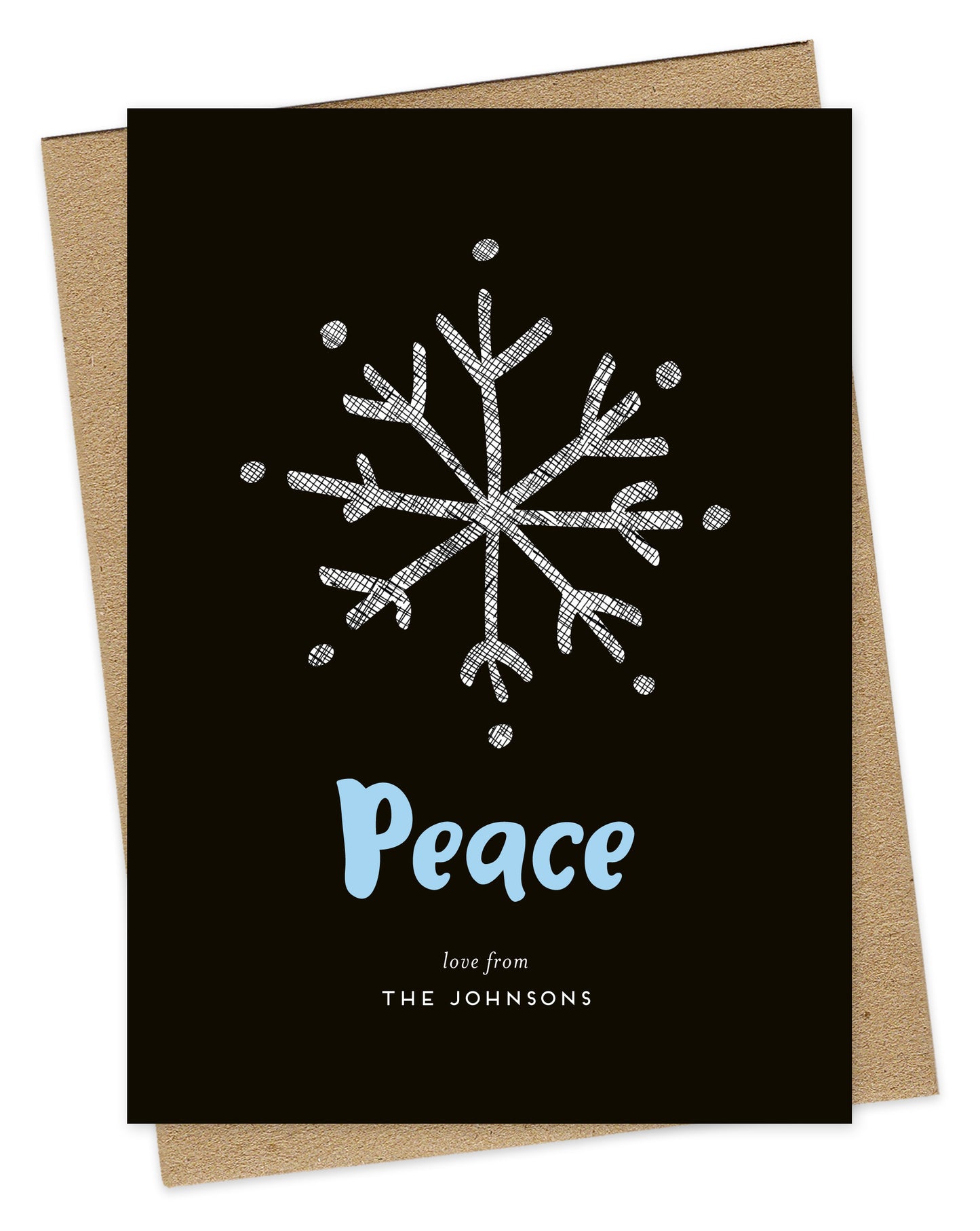 Customizable wood holiday card featuring a large illustrated snowflake, aqua "Peace” text and a personal greeting against a rich black backdrop. Shown with a kraft envelope.