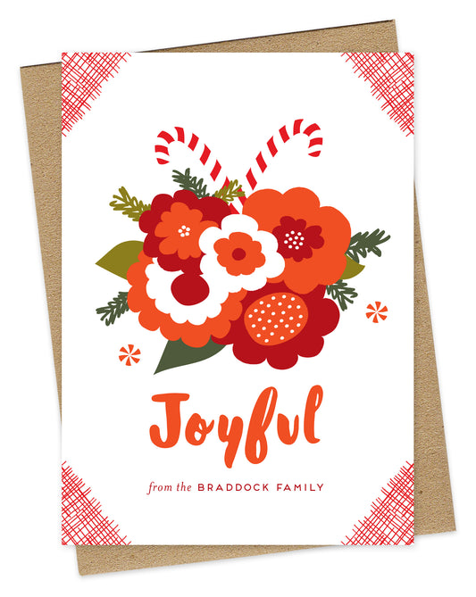 Customizable paper holiday card with a festive bouquet of flowers and candy canes, “Joyful” text and a personal message on a white background. Shown with a kraft envelope.
