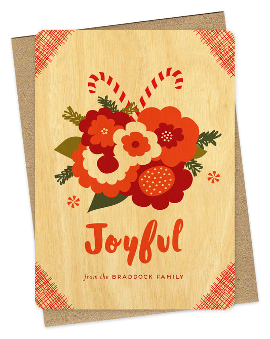 Customizable birch wood holiday card with a festive bouquet of flowers and candy canes, “Joyful” text and a personal message on a white background. Shown with a kraft envelope.