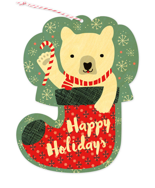 Front of die-cut wood holiday ornament card featuring a polar bear in a festive red stocking with "Happy Holidays" text and a snowy aqua background.