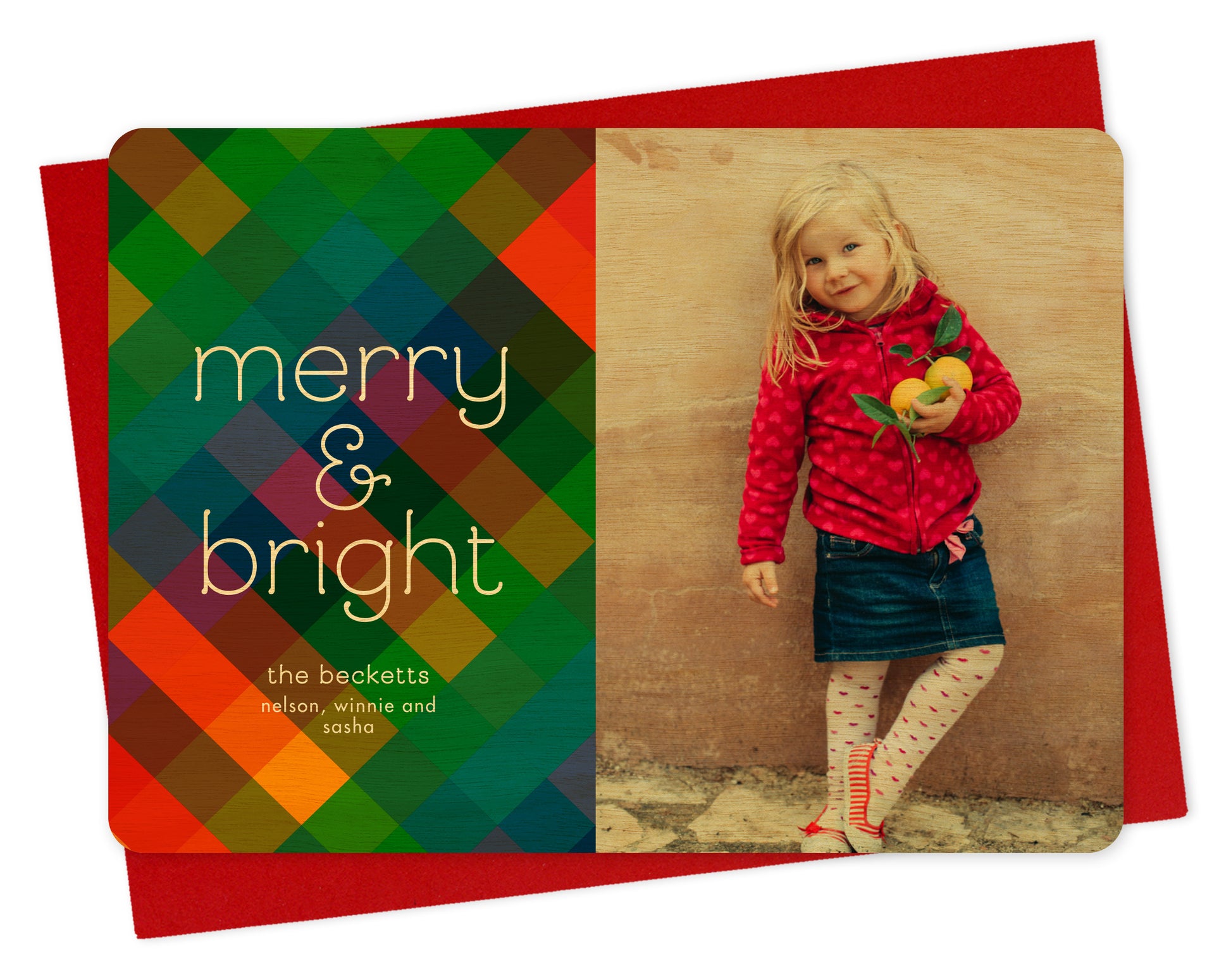 Customizable wood holiday card featuring a photo on the right and a colorful patchwork pattern with “merry & bright” text and a personal greeting on the left. Shown with a red envelope.