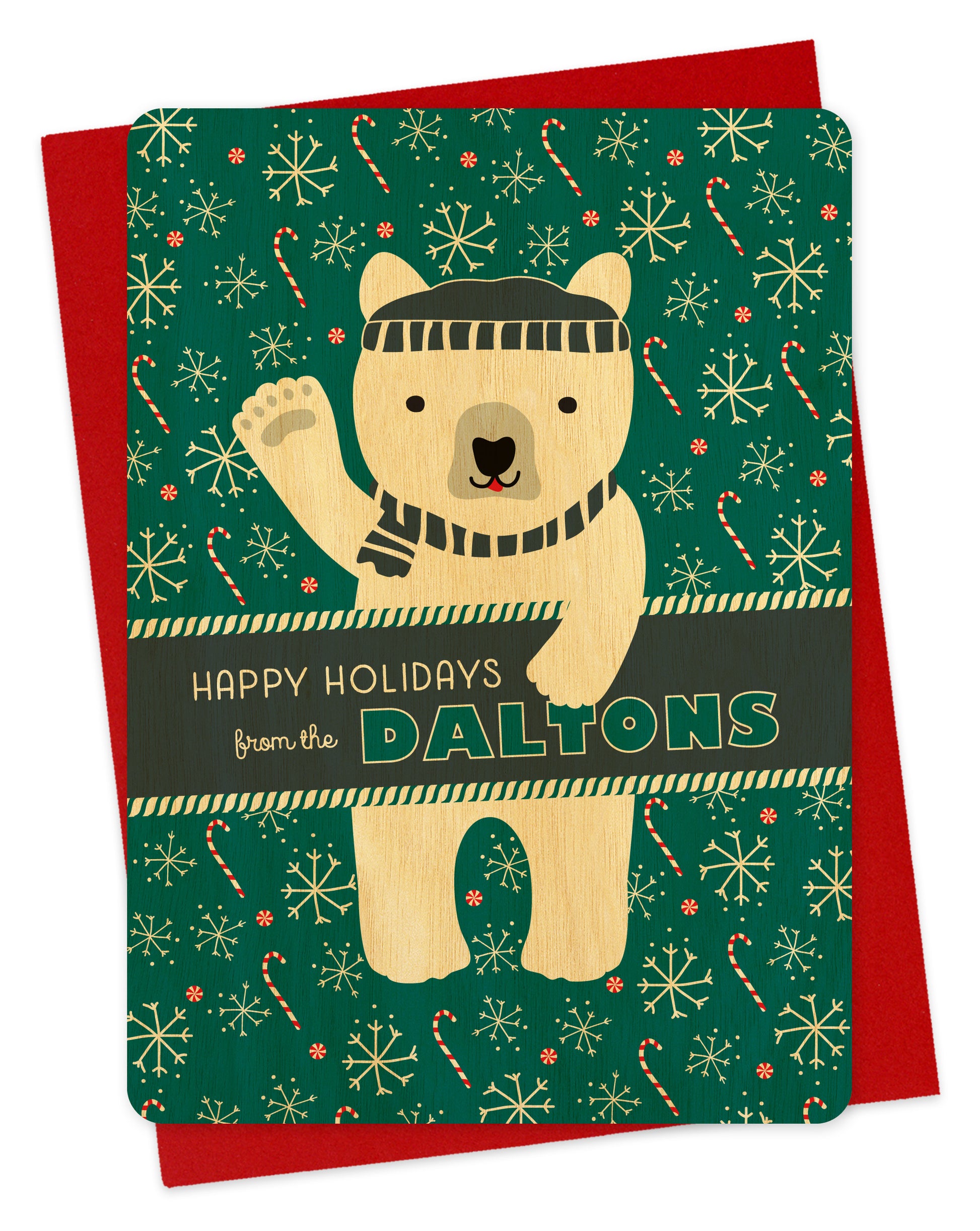 Customizable birch wood holiday card featuring a waving polar bear in a beanie and scarf against an aqua background with candy canes and snowflakes. A banner across the middle displays a personal greeting. Shown with a red envelope.
