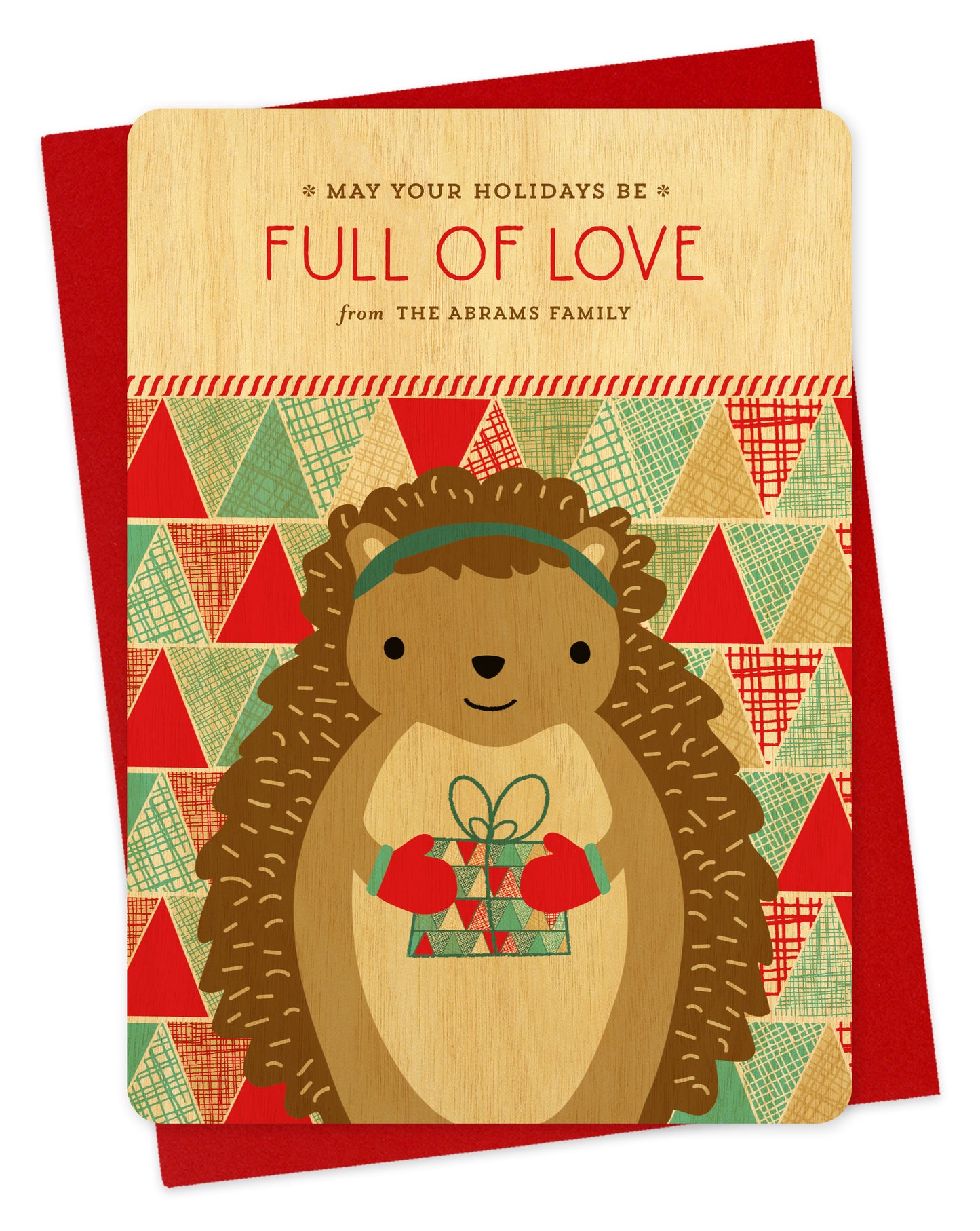 Customizable birch wood holiday card featuring a cute gift-giving hedgehog, “May Your Holidays Be Full Of Love” text and a personal greeting on a colorful, patchwork background. Shown with a red envelope.