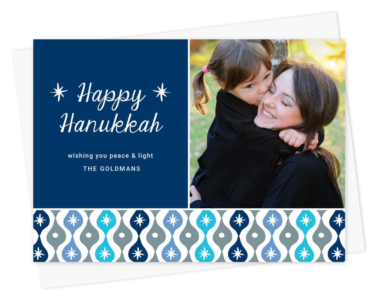 Customizable paper Hanukkah photo card featuring a family picture and personal message on a blue background with a decorative sparkle design banner in shades of blue. Shown with white envelope.