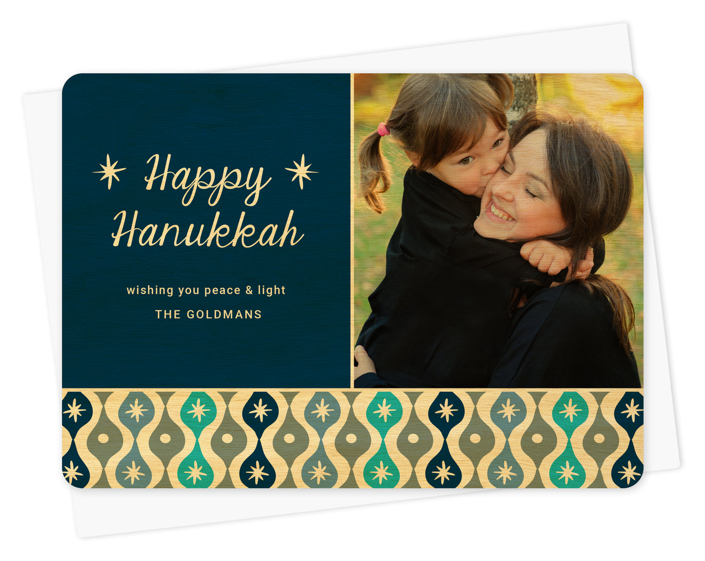 Customizable birch wood Hanukkah photo card featuring a family picture and personal message on a blue background with a decorative sparkle design banner in shades of blue. Shown with white envelope.