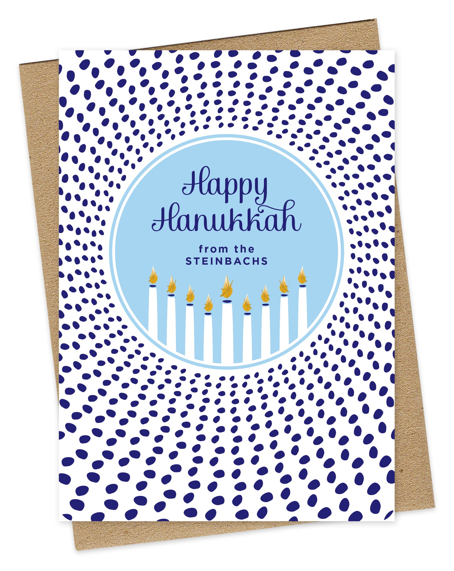 Customizable paper Hanukkah card featuring a glowing menorah inside a light blue medallion that reads “Happy Hanukkah” along with a personal greeting. The medallion is surrounded by scattered dark blue dots. Shown with a kraft envelope.