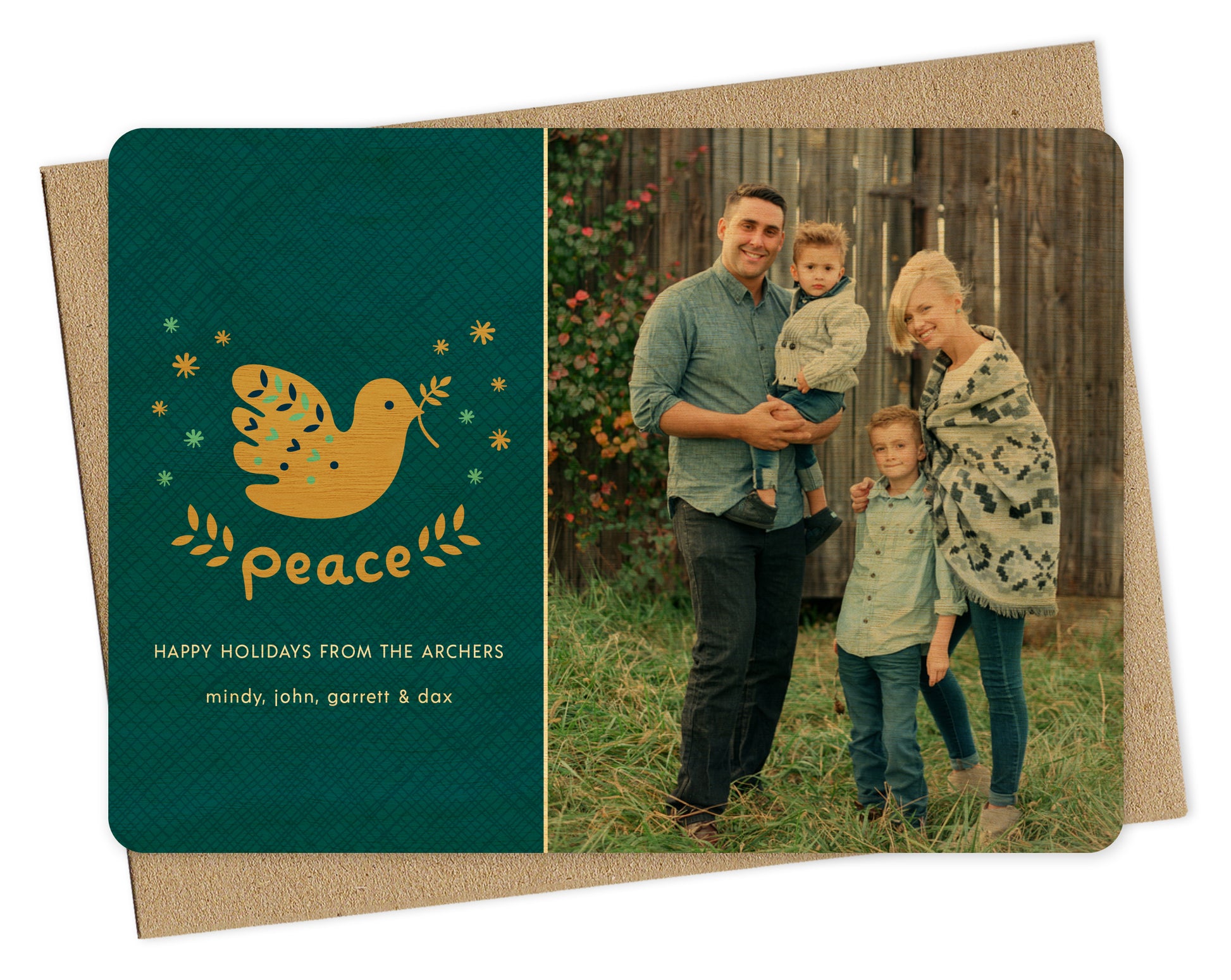 Customizable wood holiday card featuring a family photo on the right and a blue crosshatch pattern with “Peace” text, a dove carrying an olive branch and a personal greeting on the left. Shown with a kraft envelope.