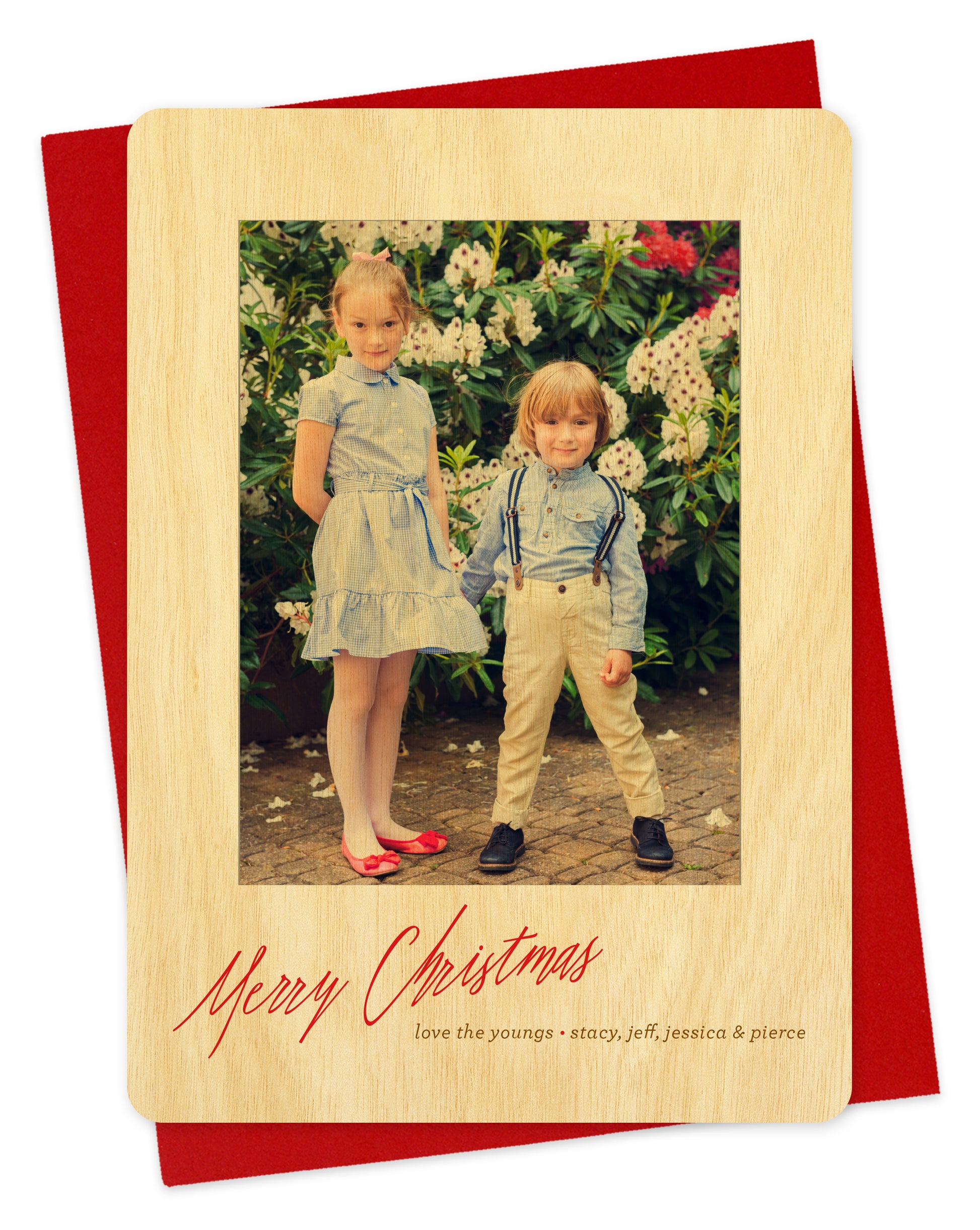 Customizable wood holiday card featuring your photo bordered by birch wood with "Merry Christmas" text near the bottom. Shown with a red envelope.