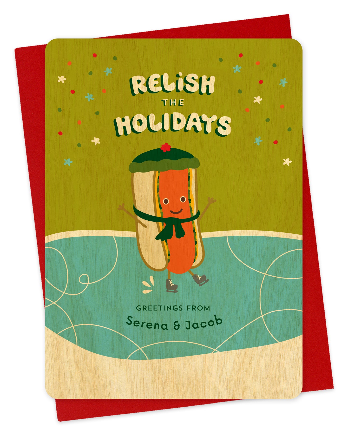 Customizable birch wood holiday card featuring a cheerful ice skating hot dog, a "Relish the Holidays" sentiment and a personal greeting. Shown with a red envelope.