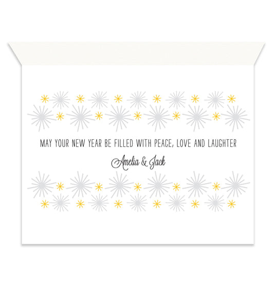 Inside of folded new year card with coordinating gold and grey starbursts and a personal greeting.