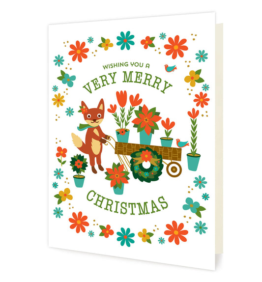 Front of folded holiday card featuring a cute illustrated fox pushing a flower cart surrounded by colorful holiday florals and the message “Wishing You a Very Merry Christmas.