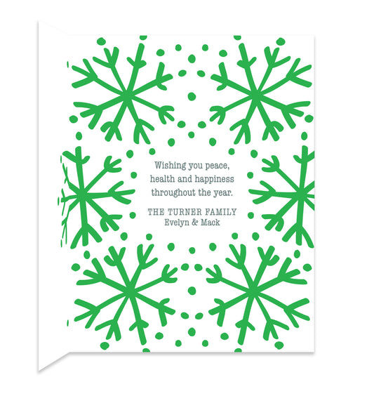 Inside of folded holiday card with coordinating green snowflake design and personal message.