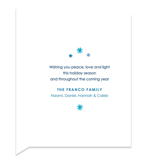 Inside of folded holiday card with coordinating blue stars and a personal greeting.