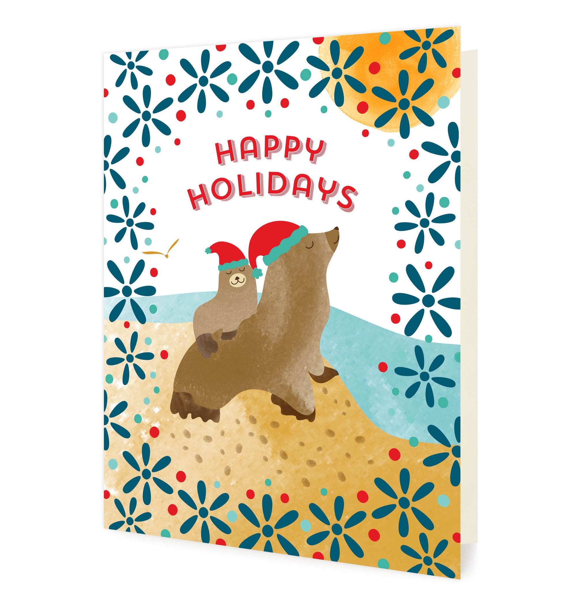 Front of folded Christmas card featuring a sea lion family wearing Santa hats in a festive coastal scene with “Merry Christmas” text.