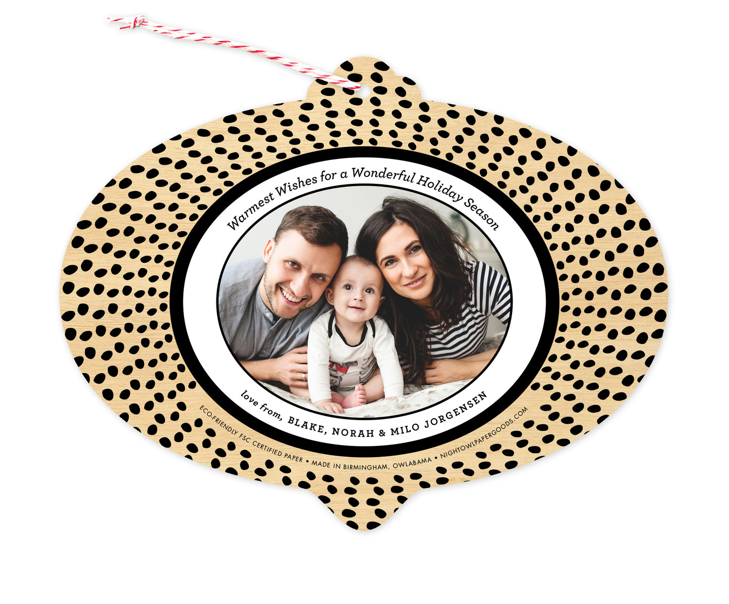 Back of customizable bulb-shaped paper holiday ornament card with Photo + Text Back option showing a personal photo and message bordered by black speckles on a printed birch wood background.