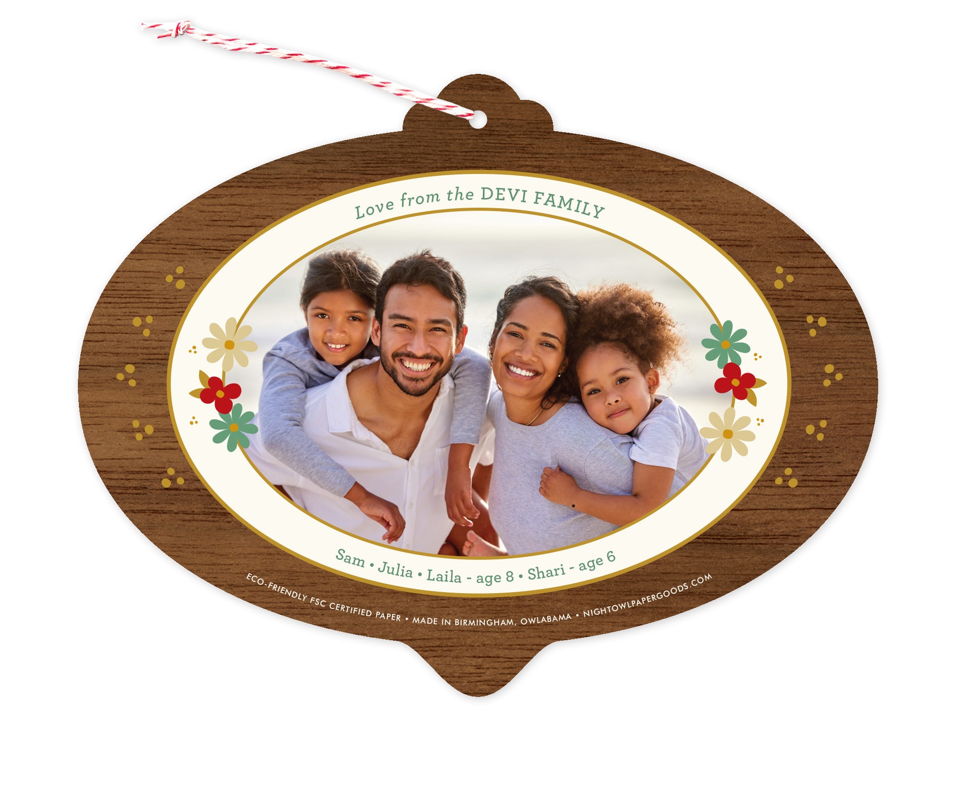 Back of customizable bulb-shaped paper holiday ornament card with Photo + Text Back option showing a personal photo and message accented by several small flowers and a printed walnut wood grain border.